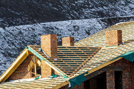 Bukovel, Ukraine - November 27, 2017: New modern house under construction. Wooden roof frameのeditorial素材