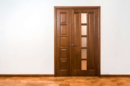New brown wooden door in house interiorの写真素材
