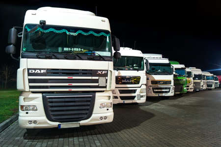 Rothenburg ob der Tauber, Germany - November 12, 2017: Trucks on a parking lot at night. Cargo...