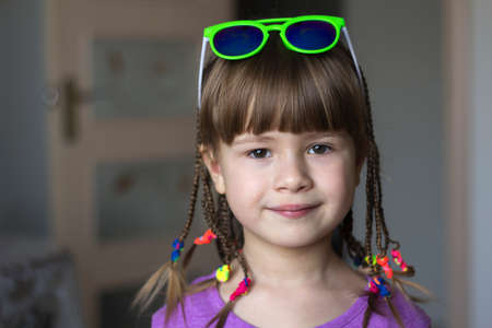 Portrait of pretty little girl with small braidsの写真素材