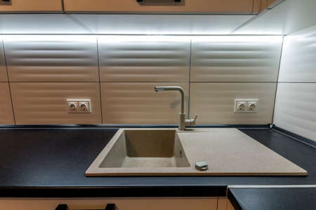 Granite sink and water faucet in new modern kitchen interiorの写真素材