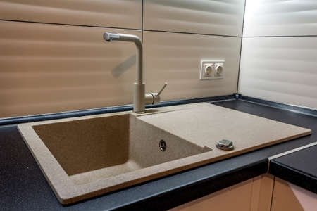 Granite sink and water faucet in new modern kitchen interiorの写真素材