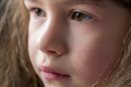 Close up portrait of happy smiling little girl with beautiful thick hairの写真素材