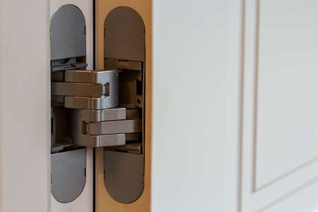 New modern metal door hinges on white wooden doorsの写真素材