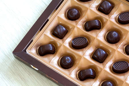Sweet chocolate candies assortment in a box close-up. Top view