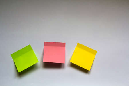 Blank colorful sticky notes isolated on white wall backgroundの写真素材