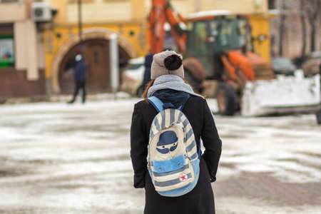 Back of young person in hat with backpackの写真素材