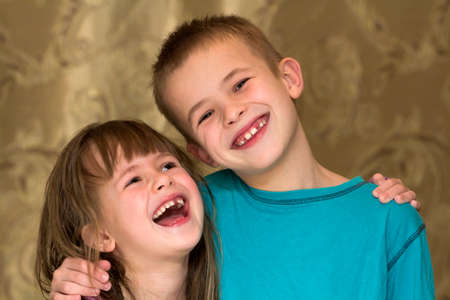 Two little children brother and sister together. Girl hugging boy. Family relations concept