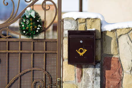 Metal post box fixed on the front gate.