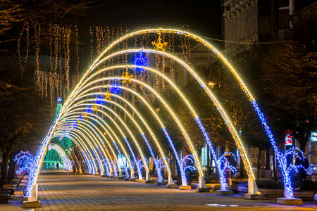Night view of New Year or Christmas decorative arches with bright lights during winter holidays in Ivano-Frankivsk city, Ukraine.のeditorial素材