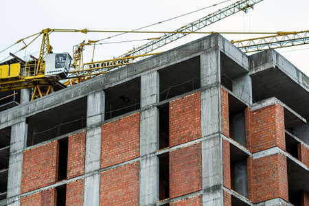 Ground view of a new modern residential house building under construction.
