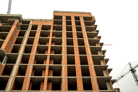 Ground view of a new modern residential house building under construction.