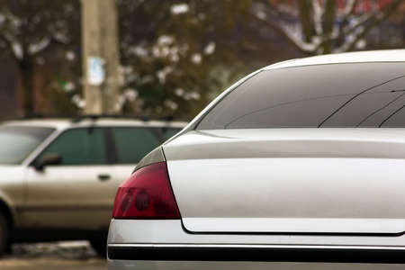 Close up of new modern cars parking on city street. Urban transportation traffic detail.の写真素材