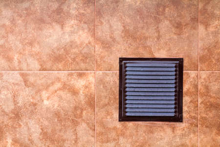 Brown metal industrial panel with ventilation grilles, closeup photo, front view. Detail of architecture design. Air circulation system.の写真素材