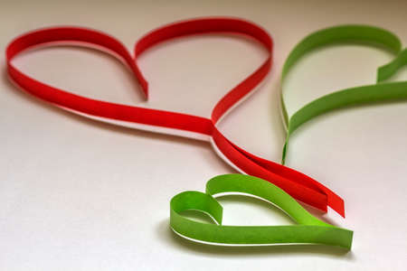 Valentine's day abstract background with cut paper colorful hearts on white.の写真素材