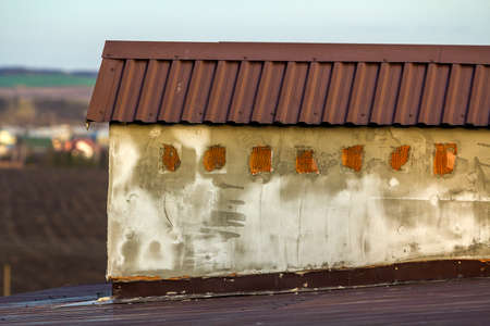 Close-up of a new built chimney on a house roof under construction. Unfinished building, repair and renovation work.の写真素材