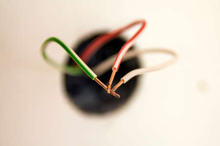 Badly wired plug electric wires showing bad and wrong dangerous connection.の写真素材