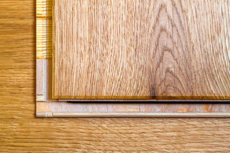 Brown wooden parquet floor planks installation , close up. Carpentry concept.の写真素材