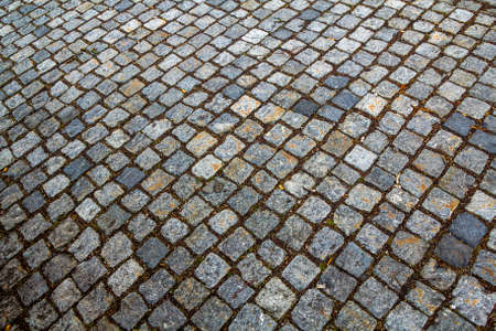 Abstract pattern of squared old-fashioned simple rough gray concrete street cobblestone pavement. Construction, decoration and background.の写真素材