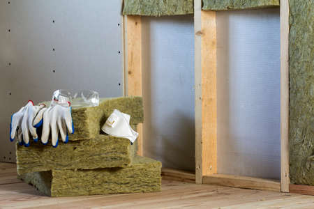 Rock wool and fiberglass insulation staff material for cold barrier. Tools for work with glass wool:...