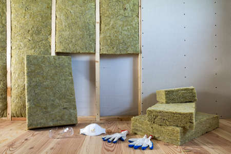 Rock wool and fiberglass insulation staff material for cold barrier. Tools for work with glass wool:...