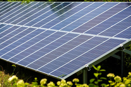 Close-up surface of lit by sun modern saving efficient stand -alone blue shiny solar photo voltaic...