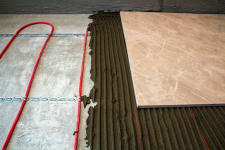 Ceramic tiles and tools for tiler. Floor tiles installation. Home improvement, renovation - ceramic tile floor adhesive,の写真素材