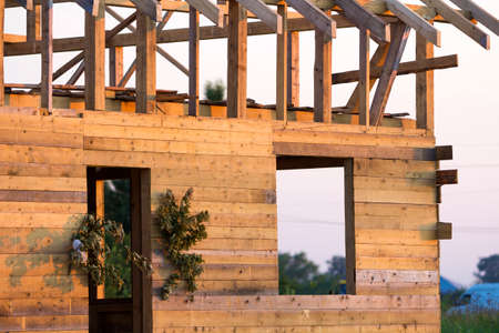 Detail view, corner of new wooden ecological traditional cottage of natural lumber materials with...