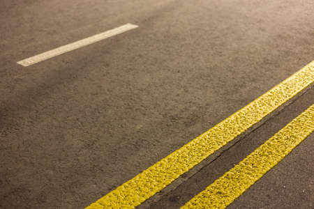 Wide bright double yellow marking sign line along modern wide smooth empty asphalt highway street...