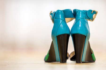 Pair of colorful bright leather strap female shoes sandals on high black platform isolated on light copy space background. Style and fashion, modern comfortable footwear for summer concept.の写真素材