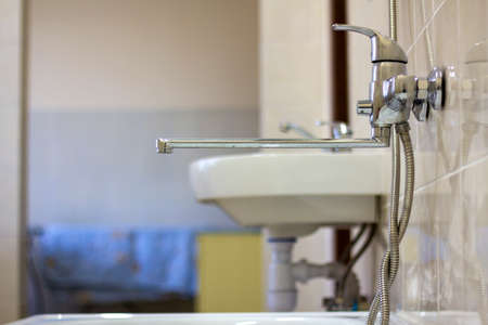 Water tap, chrome stainless metal faucet connected to shower stall tiled wall, mixer cold hot water...