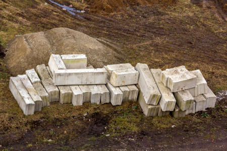 Stack of rough natural brown uneven different sizes and forms stone concrete cement blocks for...