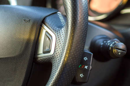 Luxurious car interior. Dashboard and steering wheel in black gray color. Transportation, design,...