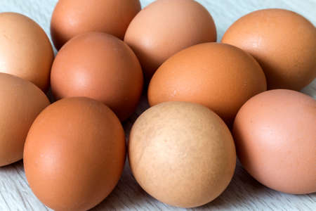 Hen eggs on kitchen table background. Healthy organic food, delicious meal, cholesterol and diet...