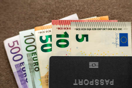 Travel passport and money, Euro banknotes bills on copy space background, top view. Traveling and ...