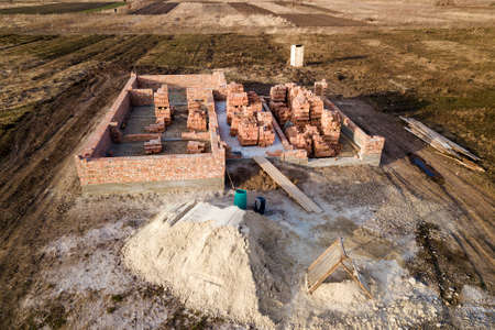 Aerial view of building site. Trenches dug in ground and filled with cement as foundation for future...
