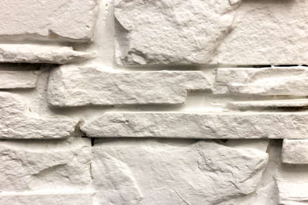 Close-up of white solid limestone wall or stone fence. Abstract copy space background, Bricklaying,...