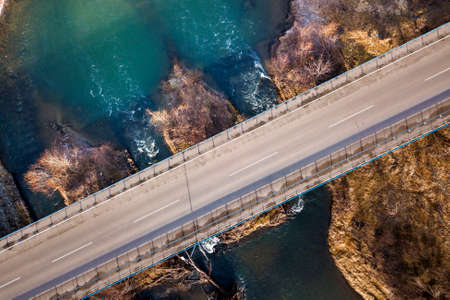 Aerial view of white bridge over blue water and stony islands.の写真素材