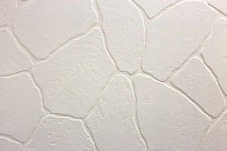Close-up of bright white plastered uneven stucco wall. Abstract texture, chaotic copy space...