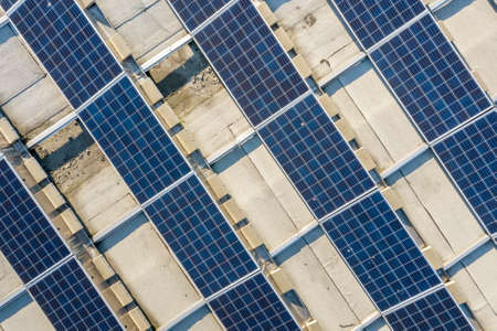 Top view of blue shiny solar photo voltaic panels system producing renewable clean energy abstract background.の写真素材