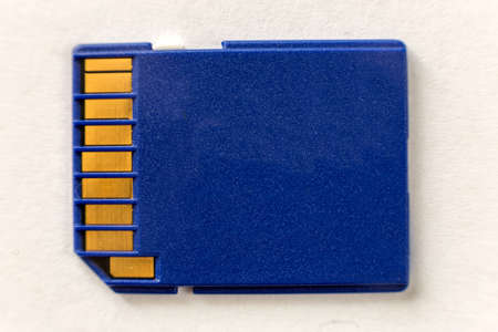 Close-up of blue micro SD memory card isolated on white copy space background. Modern electronic...