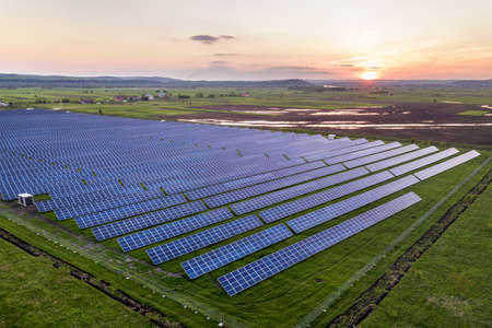 Blue solar photo voltaic panels system producing renewable clean energy on rural landscape and...