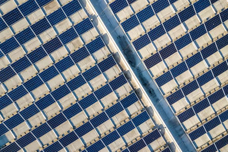 Top view of blue shiny solar photo voltaic panels system producing renewable clean energy abstract background.の写真素材