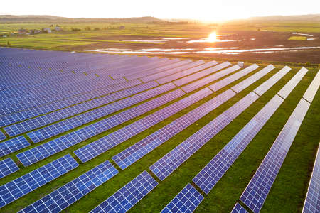 Blue solar photo voltaic panels system producing renewable clean energy on rural landscape and...