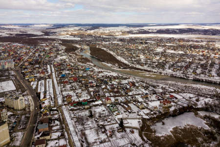 Top view of winter city landscape with tall buildings. Drone aerial photography.