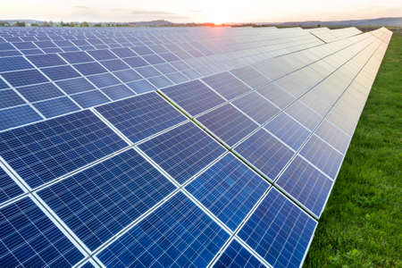 Blue solar photo voltaic panels system producing renewable clean energy on rural landscape and...