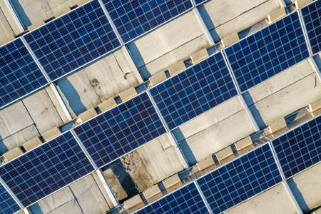 Top view of blue shiny solar photo voltaic panels system producing renewable clean energy abstract...