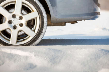 Close-up of car wheels rubber tire in deep snow. Transportation and safety concept.の写真素材