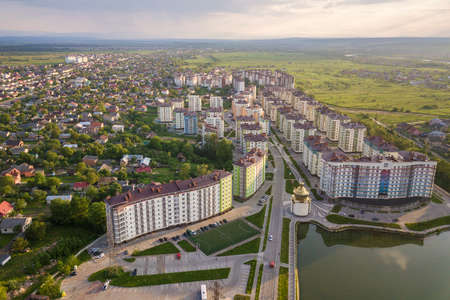 Top view of urban developing city landscape with tall apartment buildings and suburb houses. Drone aerial photography.の写真素材