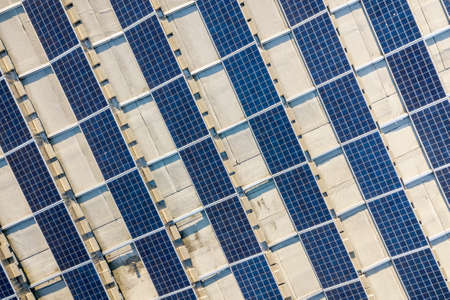 Top view of blue shiny solar photo voltaic panels system producing renewable clean energy abstract...